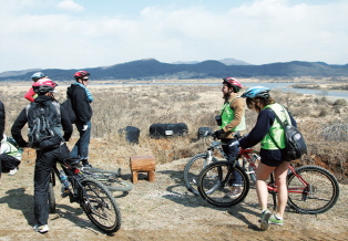 Riders stop riding for a moment and admire the mountains and fields in the distance